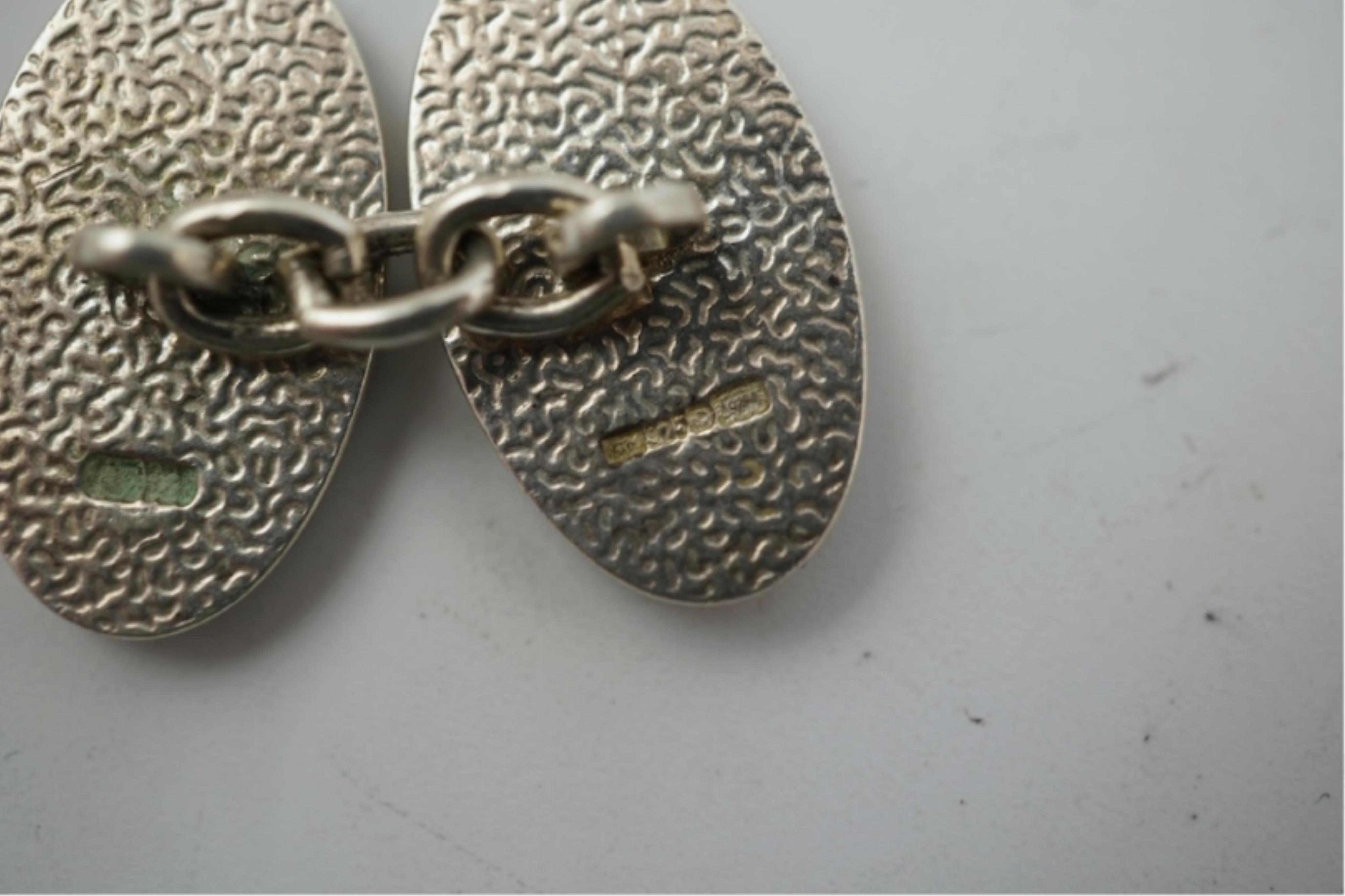 A modern pair of silver and polychrome enamel set oval cufflinks, 18mm.